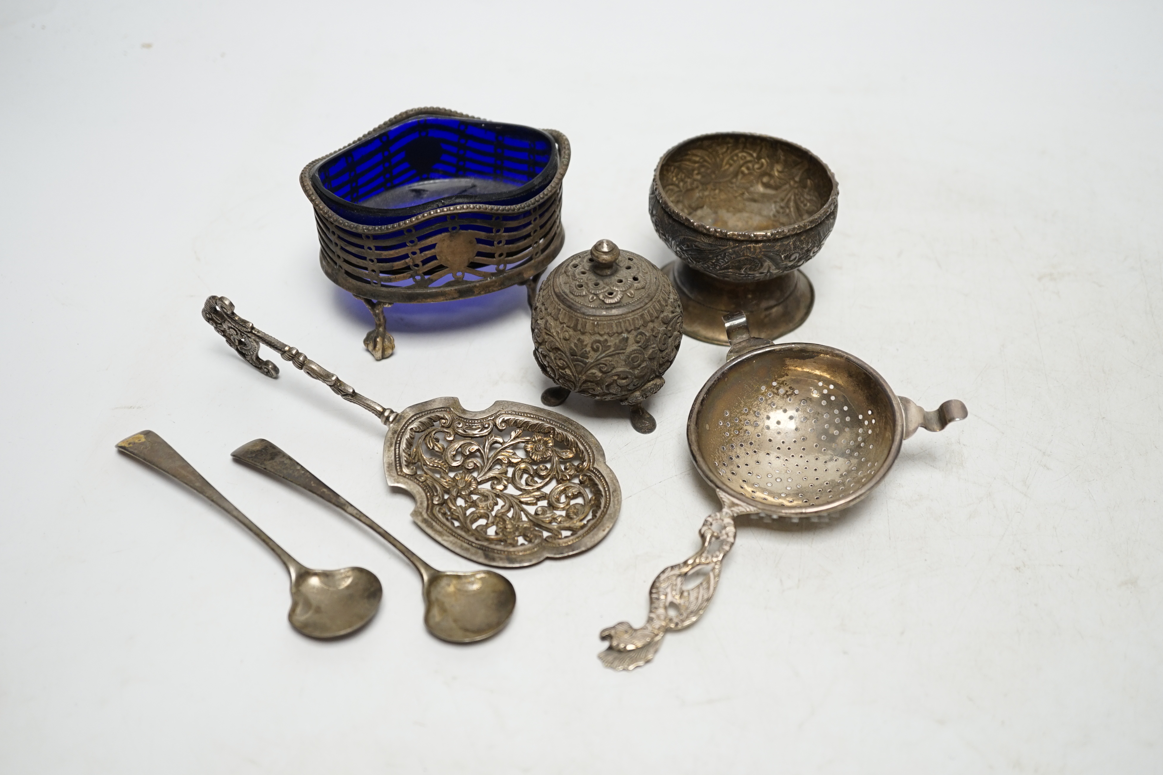A group of small silver and white metal items including a George III oval salt, two Georgian condiment spoons, Indian condiment, etc. Condition- Fair.